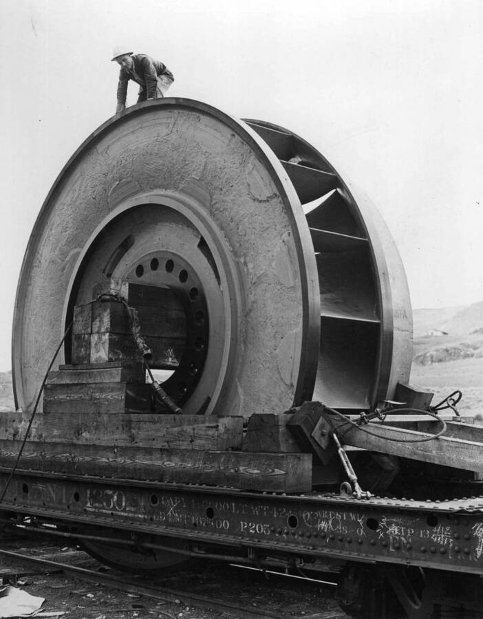 One steel casing for a giant turbine at the Grand Coulee Dam makes a full carload. Water from the Columbia River, falling through this 16-foot runner at the rate of 141 tons a second, will drive the biggest electric generator ever built, to produce electricity for the manufacture of aluminum, vital need of the defense program.