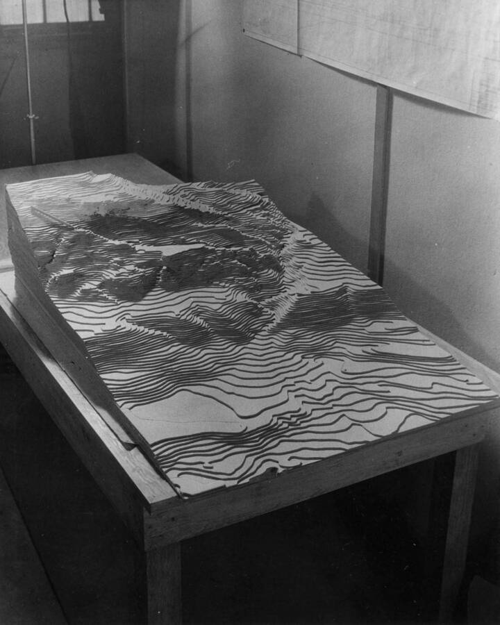 Photograph is a side angle of a topographical map where the dam will be built.