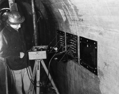 An unidentified man testing electrical.
