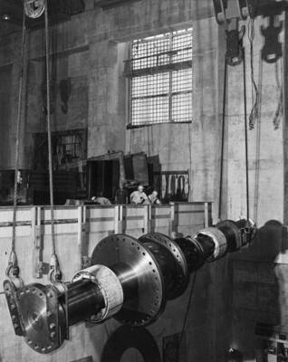 Shaft for Shasta generator being lifted preparatory to seating upright in operating position for construction of rotor