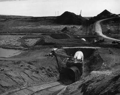 Crab Creek siphon. Photo shows workmen covering siphon in background and pouring the elbow in the foreground
