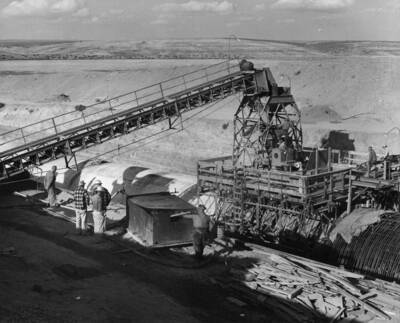 Columbia Basin Project, Irrigation Division, 2nd Section East Low Canal, Specifications No. 2603. Job fabricated wood burning hot water heating plant set up at jobsite in preparation for cold weather control of concrete temperatures. Water is pumped through a circulating coil in the fire box. See photograph 4514-4 for detail on pump hook up. Work performed by J.A. Terteling and Sons, Inc., contractor. H.E. Foss, photographer