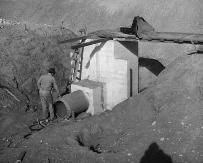 Columbia Basin Project, Irrigation Division, Specifications No. 2541, Schedule No. 2, Earthwork, Concrete Lining and Structures, Station 734+85 to Station 1229+74, West Canal. Contractor: Morrison-Knudsen Company, Inc. Lateral turnout at 1059+54 completed except for placing precast pipe and collar. West Canal located between Soap Lake, Washington and Winchester, Washington. Harold Foss, photographer.