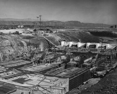 South Coulee Dam--Main Canal Headworks--View over top of barrel section taken from east upstream and west. The ladder-like templates in the middle left of the view support reinforcing steel in the hinge part of the gate section of the two west partition walls.