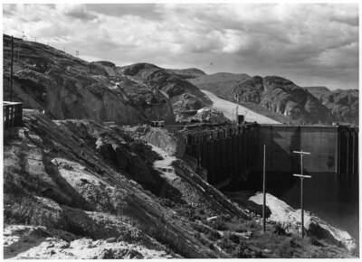View of Grand Coulee from west bank. Cranes visible on bank.
