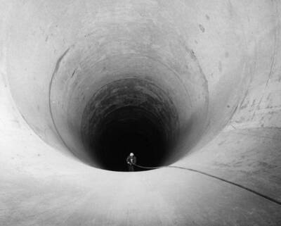 Columbia Basin Project, Irrigation Division, Bacon Siphon and Bacon Tunnel. Looking into the downstream end of the Bacon Siphon from the point where it joins the Bacon Tunnel. The structure here has an inside diameter of 23-feet, 3-inches and when in full operation will carry enough water to irrigate half a million acres.