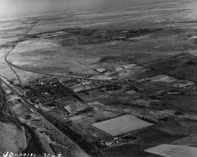 Shown here is the town of Boardman on the left side of the picture, showing U.S. Highway 30 to the upper or south of the picture. At the lower left hand corner of the picture may be seen the Union Pacific Railroad right of way. The entire town of Boardman will be moved from this site to a site at the upper left hand side of this picture near the dark area. The new interstate highway 80N will run by the darkened area, with Boardman being in between the new highway and the new railroad right of way, which will be approximately where U.S. highway 30 is now.