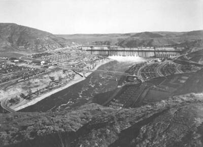 Shot with a wide angle lens, a view of the dam with employee housing on both sides of the Columbia
