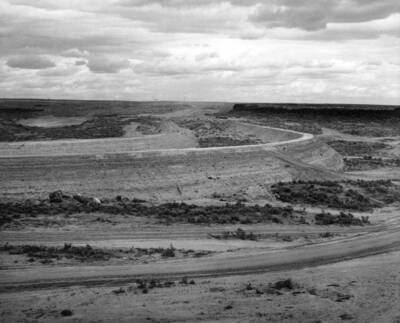 Columbia Basin Project, Irrigation Division, 1st Section Potholes East Canal, Specs. 2787. Compacted core bank construction in thoro-fill section Sta. 330 to 348. All material hauled from borrow areas by WD-10 scrapers and rolled with sheepsfoot roller. Work was performed by Guy F. Atkinson Co. under above specifications. H.E. Foss, photographer