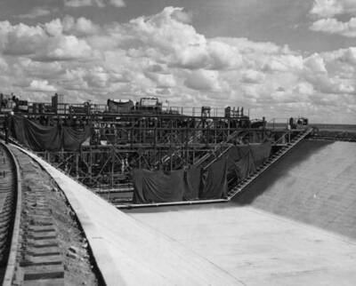 West Canal, Specs. 1286, Winston-Utah Co. Finished canal, with curing compound applied. Sprayers work from platform nearest the camera, this moves independently from the paver.