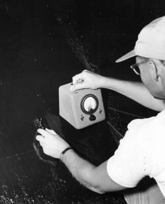 Columbia Basin Project, Irrigation Division, Soap Lake Siphon, Specifications 2411. The General Electric dry film thickness gage is being used to ascertain that the completed coal-tar enamel coating thickness conforms to specification requirements of 1/16 to 1/8 inch. This work is being performed by Walter Ferem Company, Los Angeles, sub-contractor for Winston-Utah under Schedule II of the above specifications. H. E. Foss, photographer