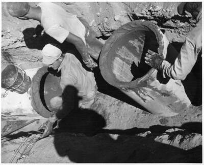 Advancing end of 21 inch reinforced (Class A-50' head) concrete pipe on the Burbank Pump Laterals HP 1.1 Station 50+25. Note groove of pipe filled with mortar. This feature under construction by Mathews Brothers about 7 miles east of Pasco, Washington. Specifications R1-CB-13. A.F. Swanson, photographer