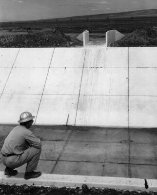 Columbia Basin Project, Irrigation Division, 2nd Section West Canal, Specs. 2541. Looking across the canal at the completed drain inlet at station 1175+44. Work is being performed by Morrison, Knudsen, Inc. under Schedule 2 of above Specifications. H.E. Foss, photographer