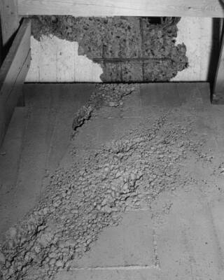 Columbia Basin Project, Irrigation Division, 3rd Section East Low Canal and Weber Wasteway Turnout. Specifications No. 2879. Rock pockets caused by insufficient vibration. Note the reinforcing steel in the lower right corner of the photograph and the hole being chipped through a repair area at left. Work performed by Western Contracting Corporation.