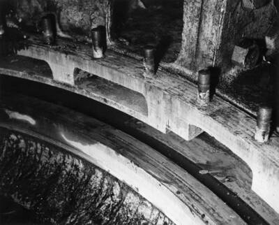 Failure of L-3 Turbine. Note: deflector plate on top of runner and the one deflector plate that was left in original position. Also scored condition of runner top rib