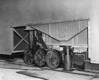 Gear system used in moving large crane on top of dam. These gears are connected to wheels resting on track that extends entirely across dam.
