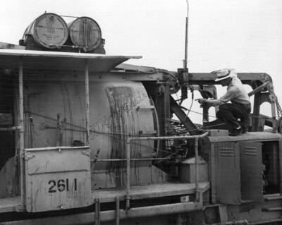 Columbia Basin Project--Irrigation Division--Main Canal--Western Contracting Corp., contractor--Specifications No. 2324. This view is intended to show the transparent plastic hose used on the discharge side of the AEA pump. The plastic hose gives visible proof that the AEA being dispensed in each batch of concrete actually feeds into the mixer. The contractor built the gravity type dispense shown in photo and it has been performing very well. H.E. Foss, photographer.