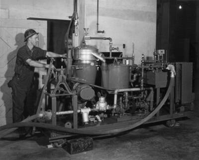 A centrifugal oil purifier, a filter, and automatic electric heater, and meter, pumps, gauges, pipes, and necessary appurtenances are mounted on a simple truck for use in various parts of the plant. The unit is designed to handle lubricating, governor, and insulating oils. Operating on insulating oil at about 90 degrees, the centrifuge is guaranteed to reduce moisture from 1/10 percent to 1/1000 percent in 1200 gallons of oil per hour, and to raise its dielectric strength to at least 30,000 volts. The filter, designed to remove carbon and fine particles that pass the centrifuge, take standard 12 inch filter papers.