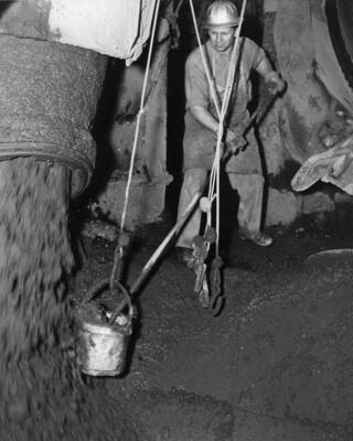 Man works with concrete during construction of Grand Coulee