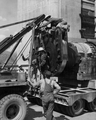 Due to lack of proper transportation equipment, difficulty was encountered in taking the R-1 rotor shaft across the spillway roadway of the dam. In order to distribute the load safely, it was necessary for this truck boom to hook onto the trailer and take some of the weight off the wheels of the trailer. (See photos 17601 and 17602-3). F.B Pomeroy, photographer