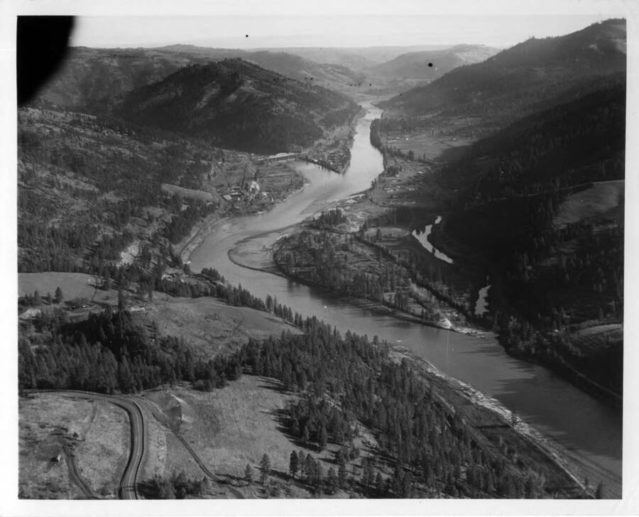 Aerial view of the valley before any work started. Looking right at the mouth of the N. Fk. of the Clearwater River and Ahsahka.  Orofino in distance.