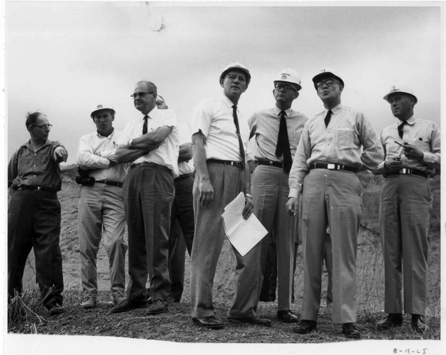 A number of Army people looking over the project on Aug. 19. Note on back: "" Left to Right: Robert Oud, Orofino; Bob Owsley, Corps of Engineers, local project supt. for a time; A.B. Curtis, Mayor of Orofino; Col. Frank D. McElwee, chief of construction for the Army; and a couple other Corps of Engineers people.""