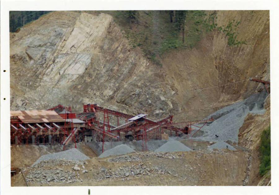 Telephoto shot taken in May of the crushed rock & sand that was used for the concrete batch plant.  Note on reverse reads 'Note the conveyor belt comes out of the mountain where the crusher was located, in a cave.  A great and nearly original progem.  Solid granite.  Different grades of rock are provided and sand, too.'