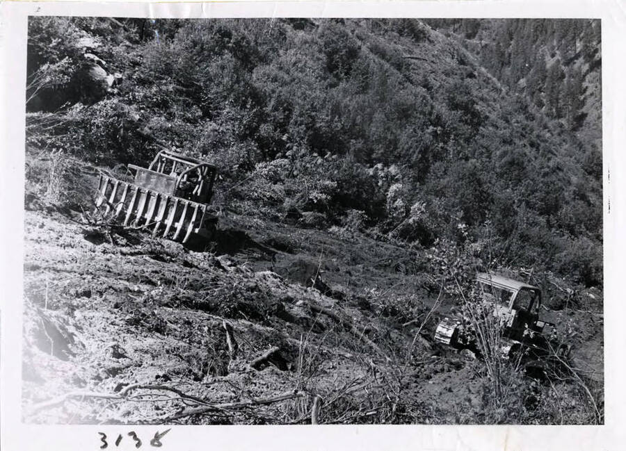 Photograph of a brush rake fitted to a bulldozer.  This is the exact kind of rake worked out by CTPA and used for piling log slash.  The contractor here adapted his for larger equipment.