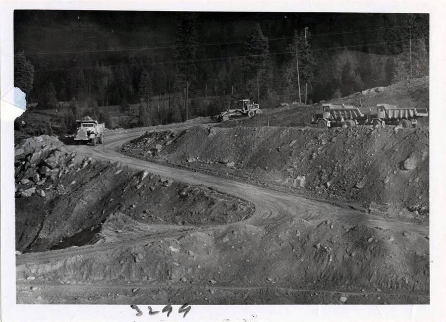 Photograph shows the truck road at dam.  Trucks haul big stuff for Coffer dam.
