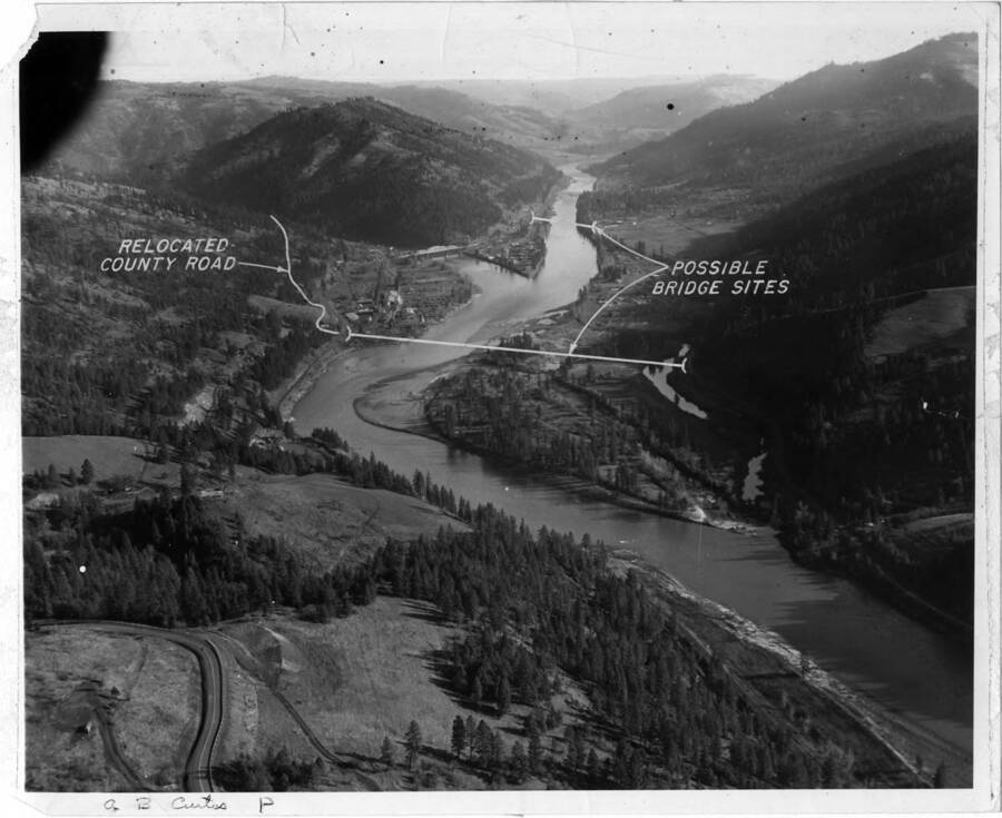 Possible bridge sites and relocated county road. Note on back: ""During the planning stages we wanted a bridge across the main river just below Ahsahka. It was to be an Army construction type of bridge and we were working with the State Highway  to get it to be a bridge for public use. Army wanted it to haul  cement and route for workers to come to the job- a saving for labor transportation, etc. The state was to put some money into it and make it a public bridge, the Army wanted to tear it down after construction. To make a long story short, the state was willing but the Army backed out of the deal and elected to divert the travel across the bridge at Orofino rather than go to the expense of a new bridge. The markings are Army. This shows the forks of the river well. (A.B. Curtis)""