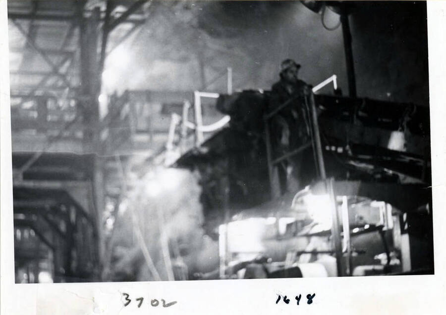Photograph showing the digging machine, and operator in the diversion tunnel.  This machine just about crawled through the mountain drilling and blasting.