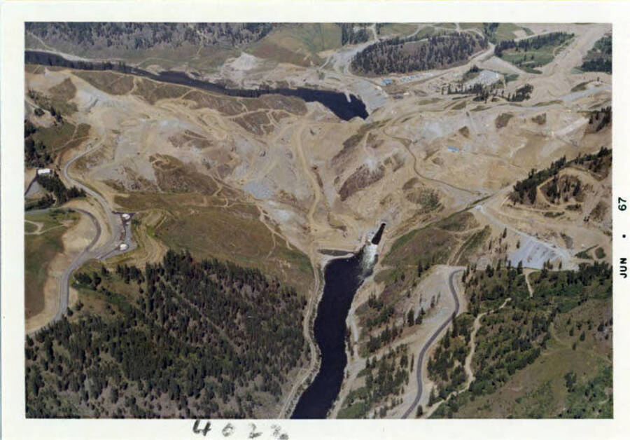 Arial photograph of the area under construction.  You can see the lower coffer dam, upper coffer dam and dry area between, as well as the diversion tunnel.  Arial view from high elevation.