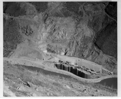 This shows the start on the lower end of the diversion tunnel and a coffer dam being built so as to permit the dam construction