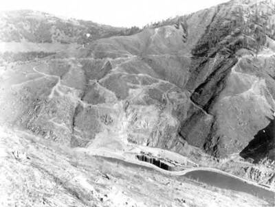 Clearing operations at dam site. Also, note the coffer dam at bottom & clearing of the area where the dam is to be built.