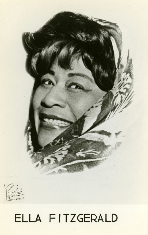Postcard containing a black and white photograph of Ella Fitzgerald wearing a headscarf