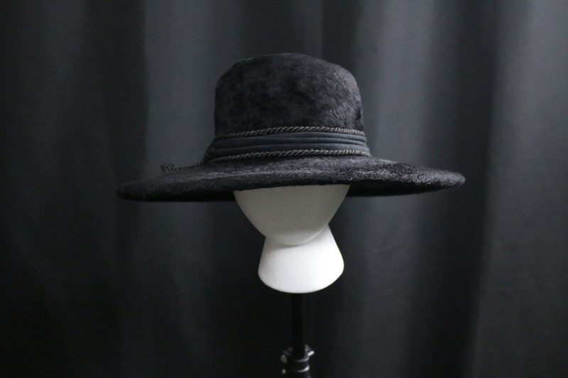 Black medium pile faux fur wide brimmed hat with black hat pin.