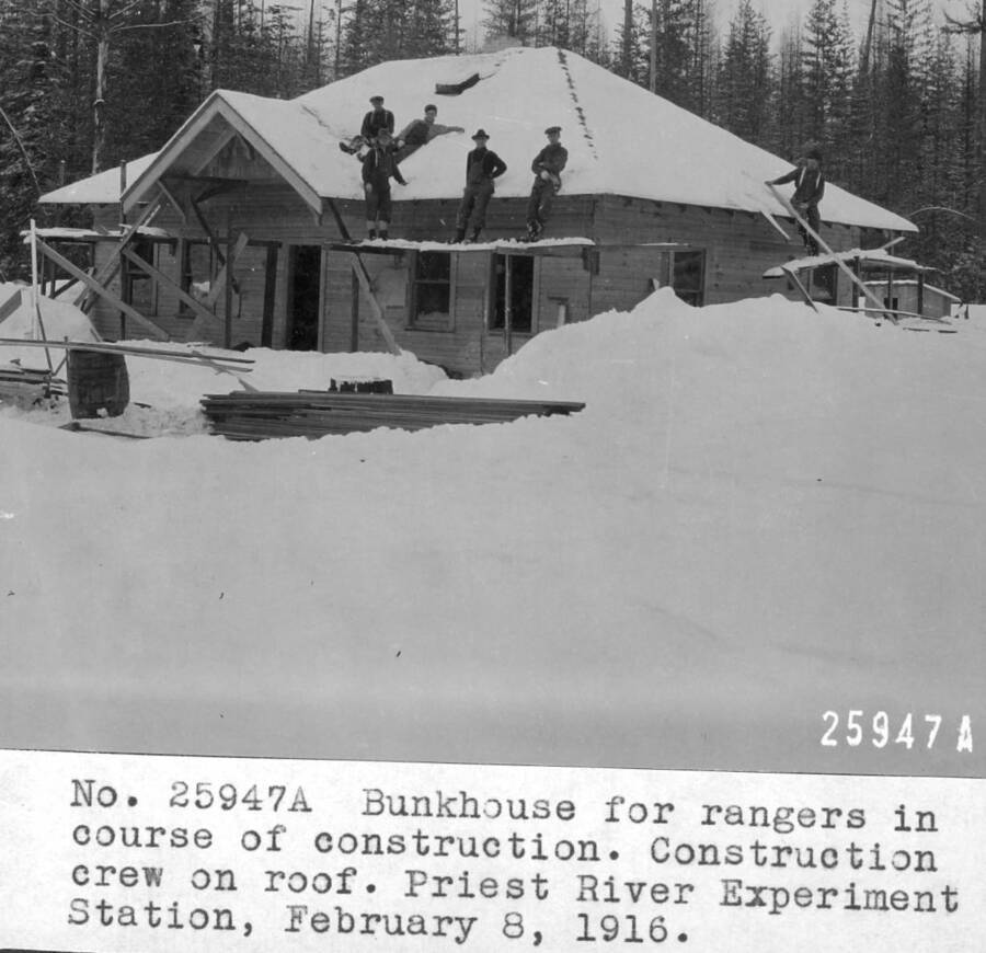 Bunkhouse in course of construction. 1916 Ranger conference. Construction crew on roof. Priest River Experimental Station. February 1916. This building was removed when the Benton Ranger Station was dismantled about 1928.
