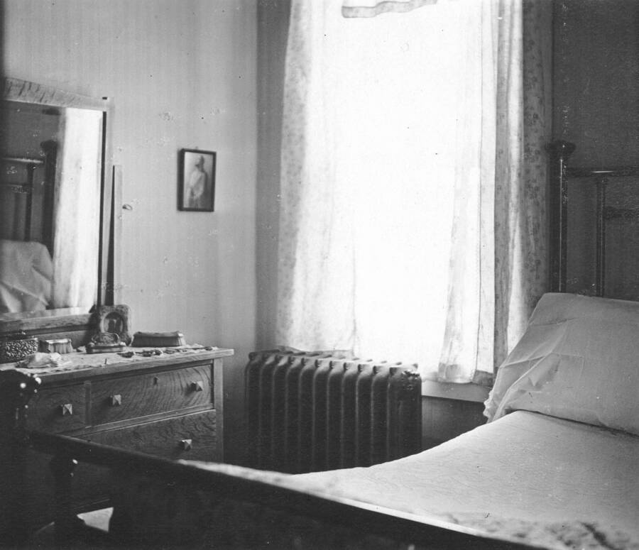 Scanned from the Larsen family album, on loan from Sue Marsh, great granddaughter of J.A. Larsen.  These are the only known photos of the interior of the original cottages.  Cottage 1 was the residence for the Larsen family 1917-21.  J.A. Larsen started as a researcher and succeeded Donald Brewster as the second Station Director.  Photo of master bedroom, cottage 1, no date, probably 1919-21 era.  Note radiator.