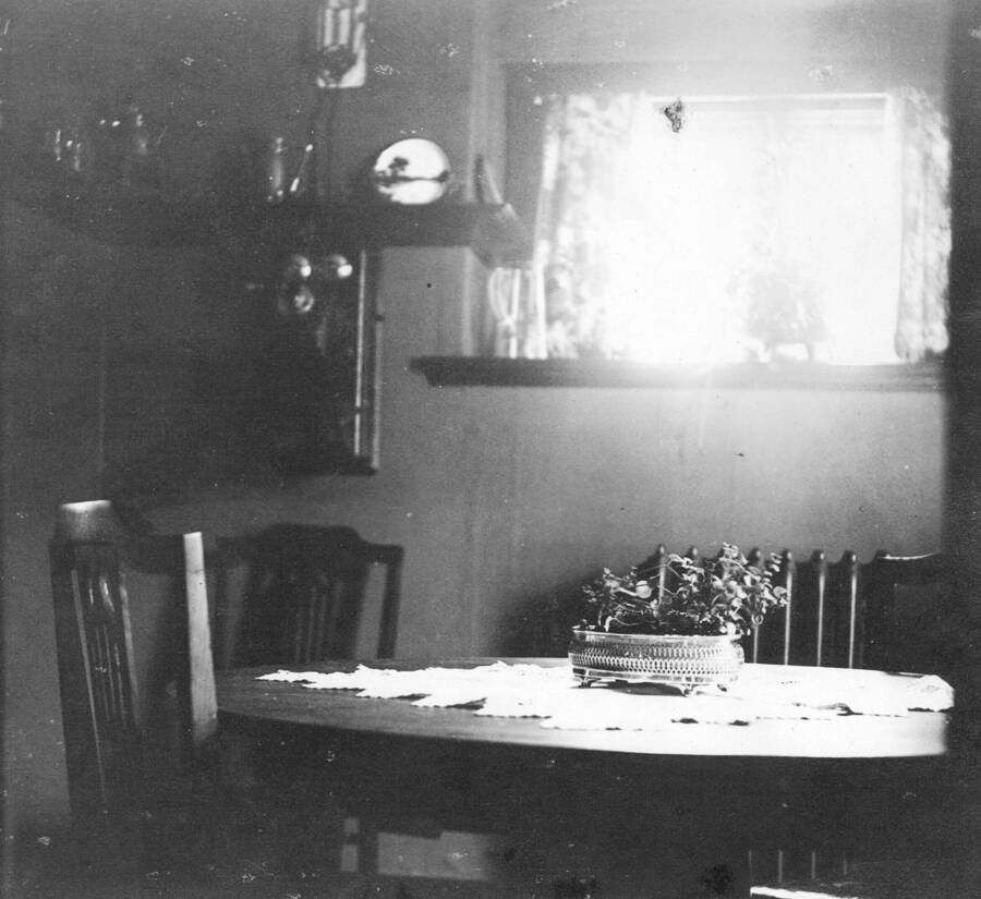 Caption titled "Dining room, Larsen home, Priest River Experimental Station, Idaho".  Note the hand crank telephone.