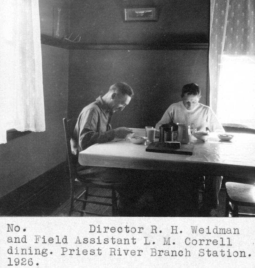 Director R.H. Weidman and Field Assistant L.M. Correll dining. Priest River Branch Station. 1926.