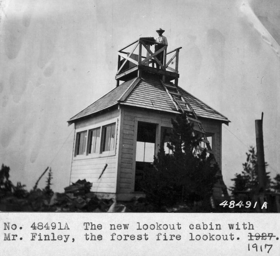 Filed in Priest Creek Experimental Forest Photo box #4: "The new lookout cabin with Mr. Finley, the forest fire lookout."
