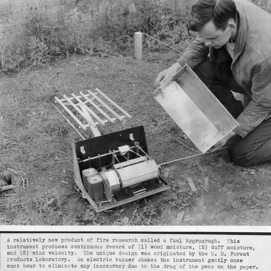 A relatively new product of fire research called a fuel bygrograph. This instrument produces continuous record of (1) wood moisture, (2) duff moisture, and (3) wind velocity. The unique design ws originated by the U.S. Forest Products Laboratory. An electric buzzer shakes the instrument gently once each hour to eliminate any inaccuracy due to the drag of the pens on the paper. G.M. Jemison pictured.