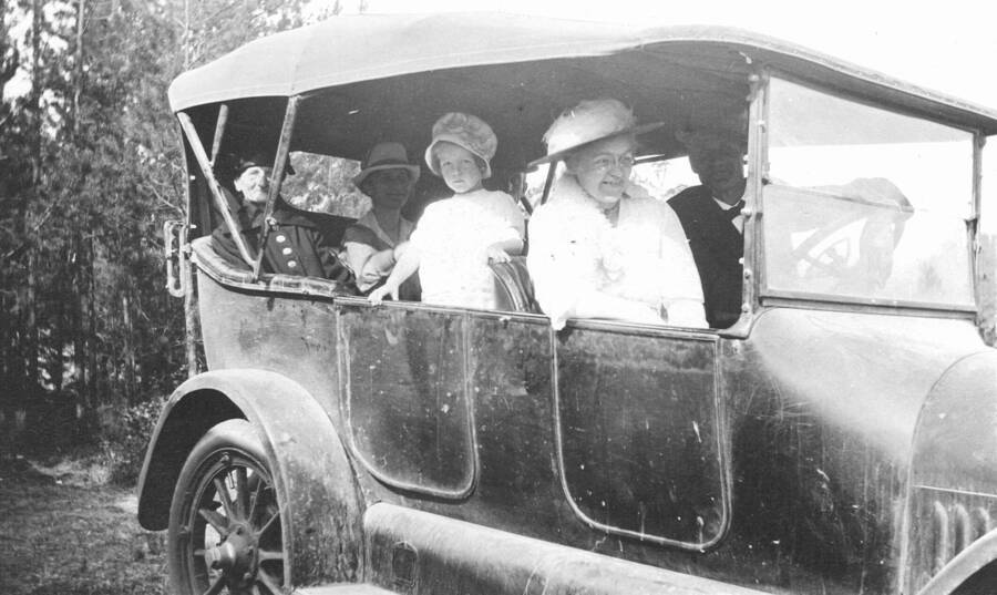 Caption titled: "Margaret and Jennie in 7-passenger Studebaker. (Note Jennie's feather hat)  This is the car that lost the front wheel when we drove to Coolin to escape the forest fire."  The fire was probably the Highlanding fire of 1922; there was mention of the fire, the drive to Coolin, and losing the front wheel of the car in the recollections of Margaret's experience at Priest River Experimental Station.  Her account has been scanned and filed in the Priest Creek Experimental Forest archive, under the subdirectory General.