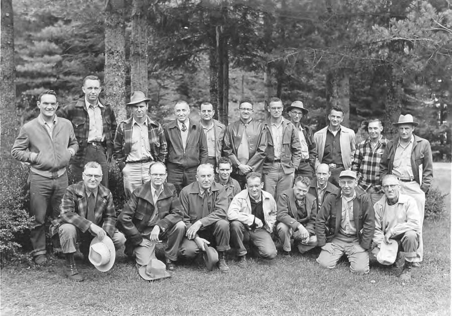 As written on the back: "Inland Empire Forest Research Advisory Committee Meeting at Deception Creek Experimental Forest, Sept. 16 and 17, 1954.  Back row, left to right: G.L. Kuhne, D.J. Schofield, R.G. Cox, L.R. Gamble, O.L. Copeland, R.F. Watt, C.D. Leaphart, W.W.  Larsen, A.B Evanko, M.W. Foiles, C.G. Krueger.  Front row, left to right: P.C. Johnson, R.W. Bailey, K. Klehm, D.P. Graham, R.J. Boyd, C.A. Wellner, M.M. Mosher, J.C. Herron, J.C. Evender."