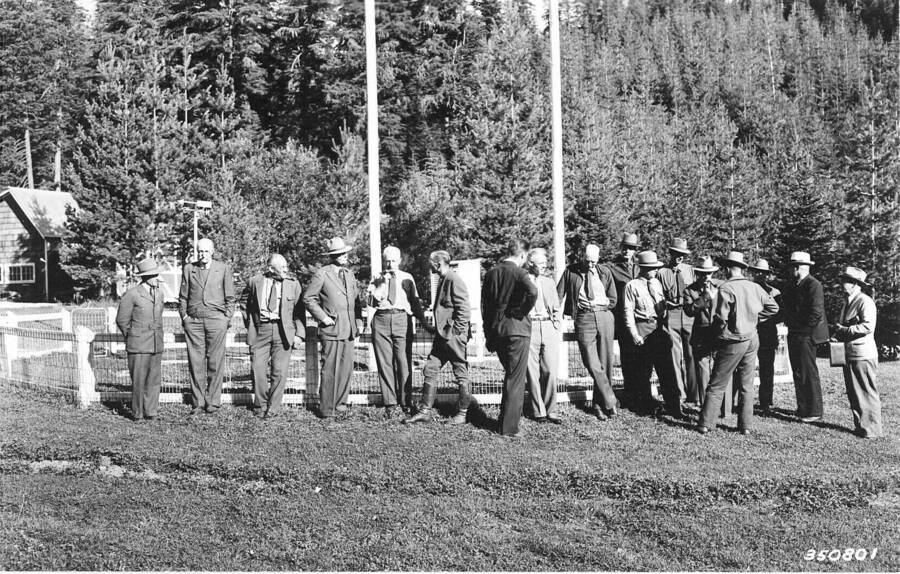 From the photo record: "Party with Pinchot and Graves, Deception Creek Expt. Forest, Aug 5, 1937.  Left to right the party includes: Howard Drake (Logging Engineer, Coeur d'Alene NF); Gifford Pinchot; Meyer H. Wolff (Ass't. Regional Forester, Recreation and Lands, R1); Herbert A. Smith; Evan Kelley (regional Forester R1); Kenneth P. Davis (Chief, Div. of Silviculture, Northern Rocky Mtn, Expt. Station);  Baron Gisbert von Romberg (visiting German forester); Stephen N. Wyckoff (Dir., Northern Rocky Mtn, Expt. Station); Charles D. Simpson (Supervisor, Coeur d'Alene NF); Virgil Moody (Timber Sales, Coeur d'Alene NF); James E. Ryan (Supervisor, Kaniksu NF); William W. Larsen (Ranger, Coeur d'Alene NF); Elers Koch (Asst. Regional Forester, Timber Management, R1); William Guernsey (Asst. Forest Supervisor, Coeur d'Alene NF); George Haynes (Staff Asst. Coeur d'Alene NF); Bill Rinkle (Pinchot's chauffer); and Henry Solon Graves (Chief)."
