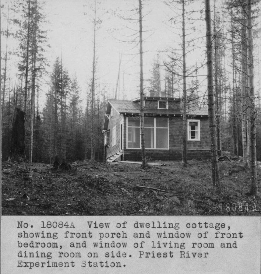 View of dwelling cottage, showing front porch and window of front bedroom, and window of living room and dining room on side. Priest River Experimental Station.