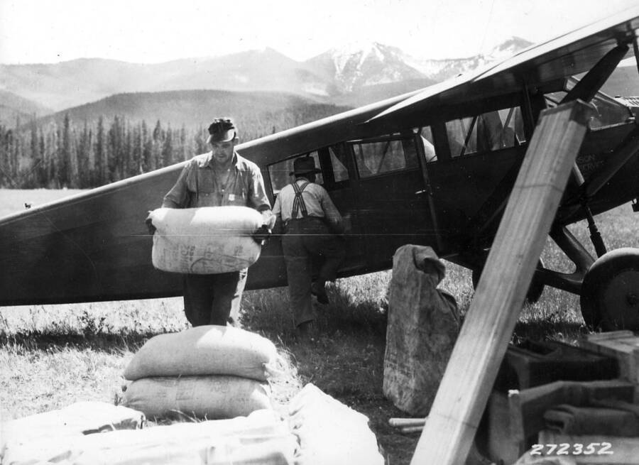 Unloading oats from plane at Bartlett Creek Landing field.