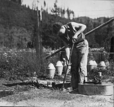 Taking soil sample at clear-cut area. P.R. Exp. For. Chuck Wellner pictured