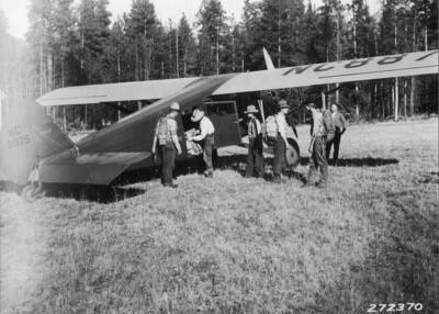 Emergency guards with packs leaving airplane at Barlett Creek landing field.