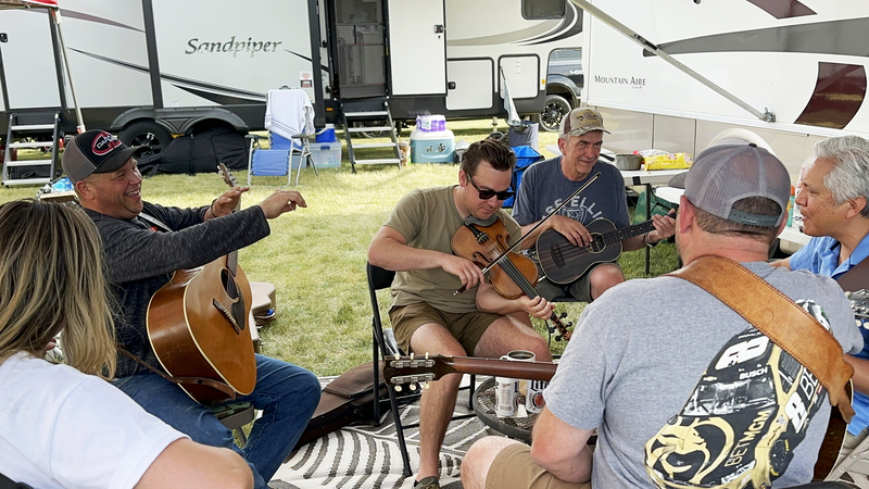 Various fiddlers practicing in the middle of the campground